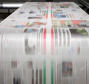 Newspapers being run on a printing machine